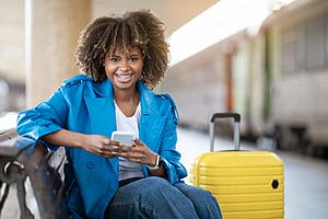 Finding a Home - female smiling holding a phone