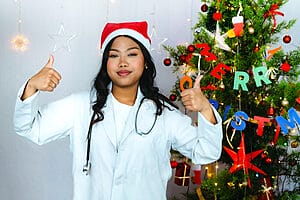 9 Things to Look Out for During Christmas Assignments 3 Female travel nurse giving thumbs up while on Christmas assignments