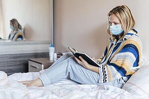 nurse resting in bed in her short term apartment